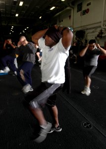US Navy 070315-N-1226D-043 Intelligence Specialist 1st Class Travoric Smith from Odessa, Texas, exercises during the Fitness Enhancement Program aboard USS Bonhomme Richard (LHD 6) hangar bay