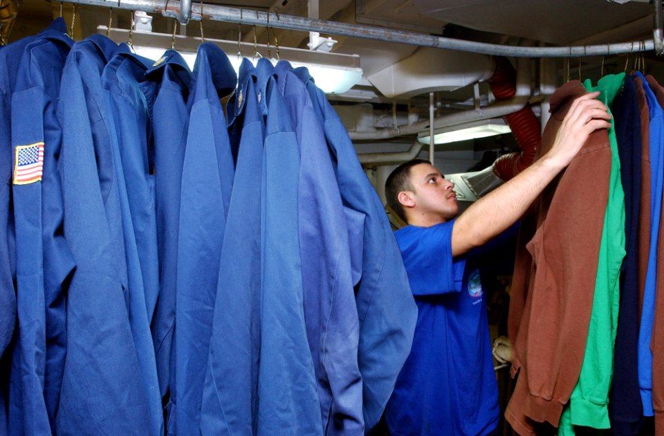 US Navy 070312-N-4009P-188 Aviation Boatswain's Mate Equipment Seaman Anthony Munoz from Fresno, Calif., hangs a chief's flight deck jersey in the laundry room aboard Nimitz-class aircraft carrier USS Ronald Reagan