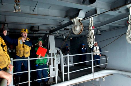 US Navy 070317-N-9712C-003 Chief Boatswain's Mate John Rolland from Van Nuys, Calif., directs movement of a single probe refueling rig as USS Ronald Reagan (CVN 76) connects to Japan Maritime Self Defense Force (JMSDF) ship.