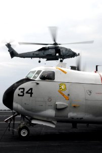 US Navy 070314-N-3659B-197 An SH-60F Seahawk, assigned to the Black Knights of Helicopter Anti-Submarine Squadron (HS) 4, prepares to touch down behind a C-2A Greyhound