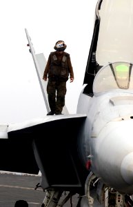 US Navy 070316-N-7130B-065 Walking the fuselage of an F-A-18E Super Hornet, a plane captain assigned to the Fighting Redcocks of Strike Fighter Squadron (VFA) 22 inspects the aircraft he is responsible for prior t