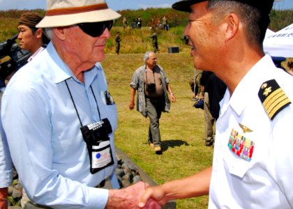 US Navy 070314-N-4124C-141 Japan Maritime Self Defense Force (JMSDF) Capt. Tomonori Kudo shakes the hand of a Battle of Iwo Jima survivor at the 62nd Commemoration of the Battle of Iwo Jima