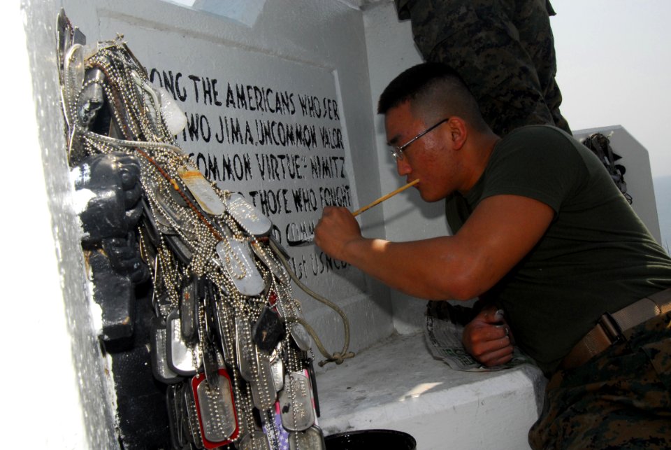 US Navy 070313-N-4124C-104 Lance Cpl. Hanmo L. Broker, assigned to Marine Corps Base Okinawa, gives a fresh coat of paint to an inscription at a shrine dedicated to the service members who fought in the Battle of Iwo Jima