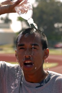US Navy 070315-N-8158F-115 Seaman Yan Chan cools his head with water after participating in the 1st Annual St. Patrick's Day 5K run held at Naval Base San Diego photo