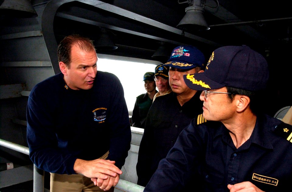 US Navy 070316-N-9712C-002 Lt. Cmdr. Cletis Strausbaugh, assigned to Nimitz-class aircraft carrier USS Ronald Reagan (CVN 76), explains the details of a refueling station to Japan Maritime Self Defense Force (JMSDF) Commander,