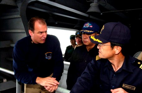 US Navy 070316-N-9712C-002 Lt. Cmdr. Cletis Strausbaugh, assigned to Nimitz-class aircraft carrier USS Ronald Reagan (CVN 76), explains the details of a refueling station to Japan Maritime Self Defense Force (JMSDF) Commander,
