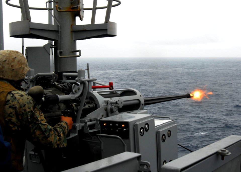 US Navy 070316-N-4124C-014 A Marine from 1st Marine Aircraft Wing (MAW) 172nd Support Squadron fires a round from a 25mm machine gun aboard dock landing ship USS Harpers Ferry (LSD 49)
