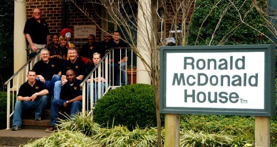 US Navy 070314-N-8923M-054 Members of the USS Harry S. Truman (CVN 75) Mustang Association pose with staff members on the steps of the Ronald McDonald House photo