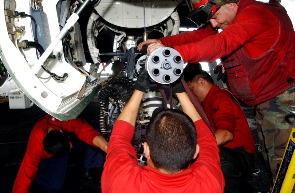US Navy 070317-N-4009P-195 Aviation ordnancemen work together to extract the 20mm Vulcan Cannon from an F-A-18E Super Hornet, assigned to the Eagles of Strike Fighter Squadron (VFA) 115, for a routine inspection