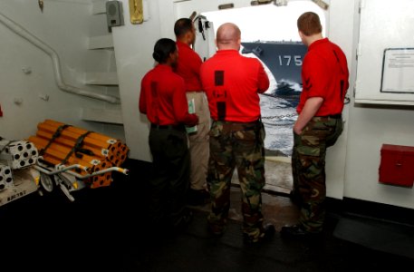 US Navy 070317-N-4009P-113 Aviation ordnancemen aboard Nimitz-class aircraft carrier USS Ronald Reagan (CVN 76) watch as the Japan Maritime Self Defense Force (JMSDF) guided missile destroyer JS Myoko (DDG 175) cruises alongsid