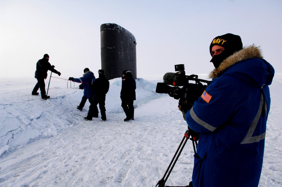 US Navy 070317-N-3642E-198 Mass Communication Specialist 2nd Class Andrew Krauss waits for the Secretary of the Navy (SECNAV), the Honorable Dr. Donald C. Winter to land and then board USS Alexandria (SSN 757) during ICEX-07