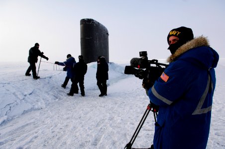 US Navy 070317-N-3642E-198 Mass Communication Specialist 2nd Class Andrew Krauss waits for the Secretary of the Navy (SECNAV), the Honorable Dr. Donald C. Winter to land and then board USS Alexandria (SSN 757) during ICEX-07 photo