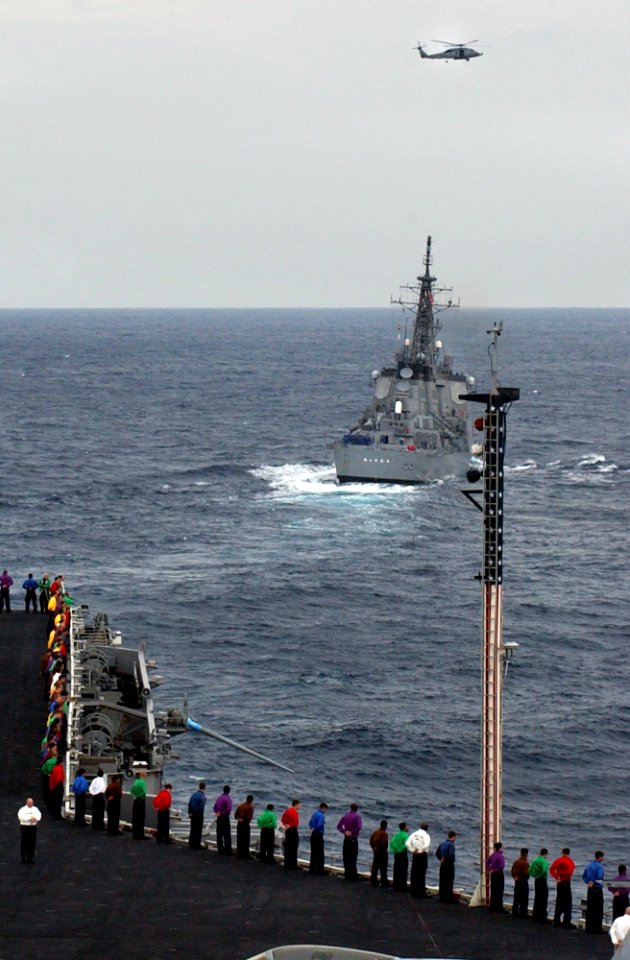 US Navy 070318-N-4009P-029 Sailors aboard Nimitz-class aircraft carrier USS Ronald Reagan (CVN 76) man the rails during a pass in review between ships from the Ronald Reagan Carrier Strike Group and Japan Maritime Self Defense