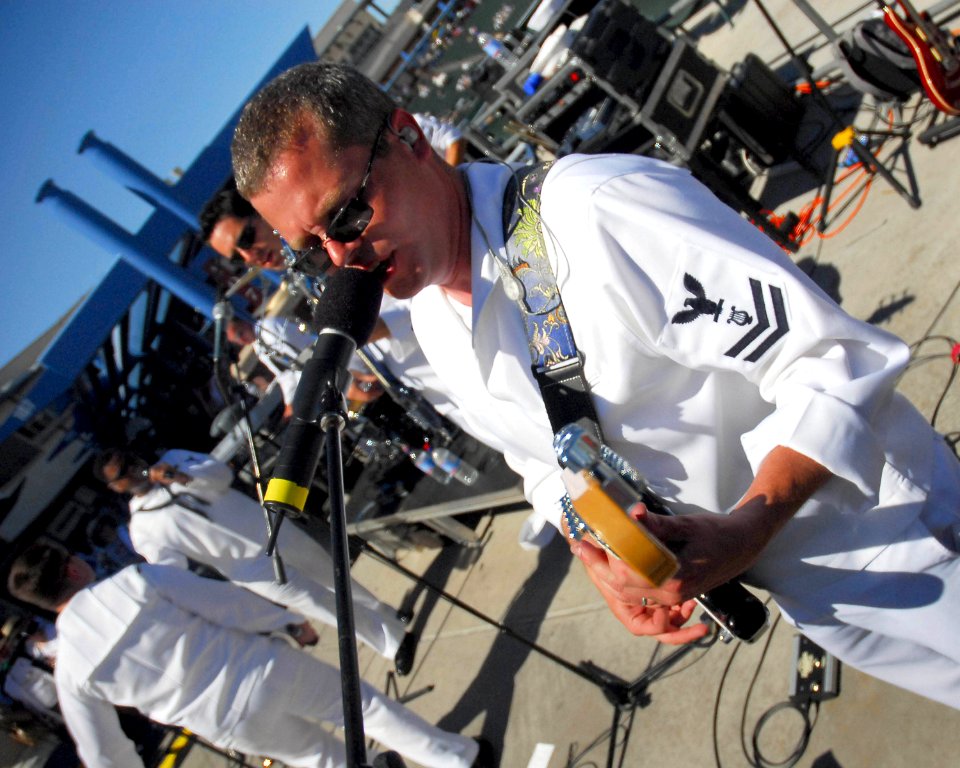 US Navy 070318-N-4774B-220 Musician 2nd Class Rob Collier of the U.S. Navy Band Southwest's contemporary ensemble performs during a Major League Baseball Spring Training preshow in Tucson during Navy Week