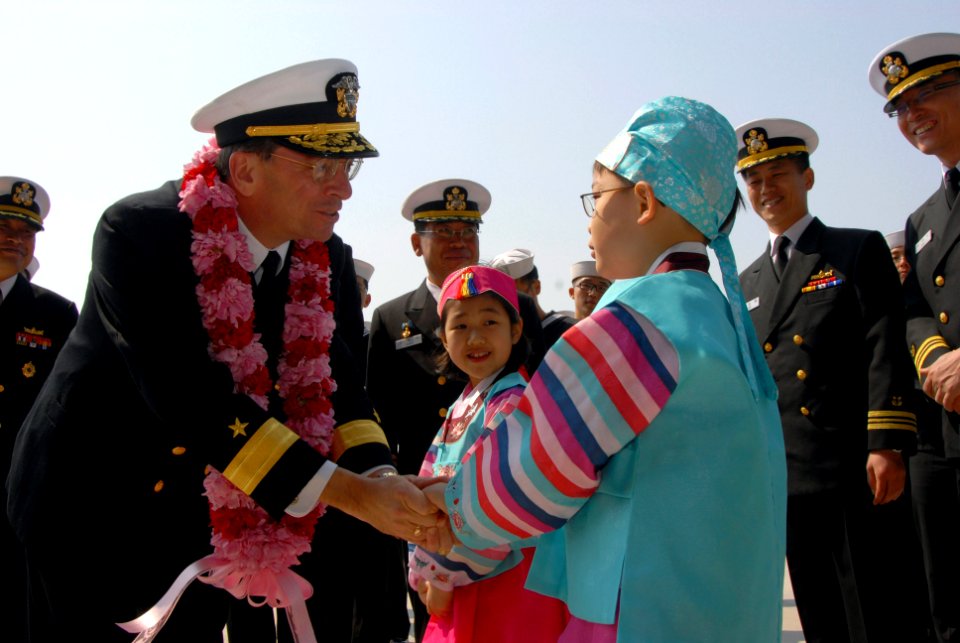 US Navy 070322-N-3659B-059 Commander, Carrier Strike Group (CCSG) 7, Rear Adm. Charles Martoglio, thanks a local child after receiving a lei from a local area child during a port visit to Busan, Republic of Korea