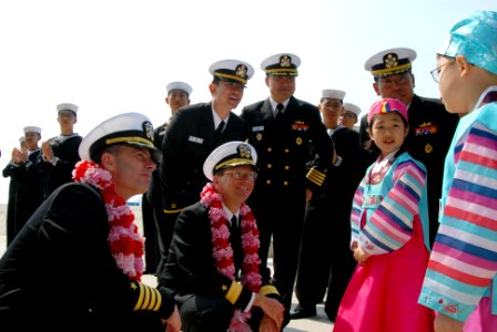 US Navy 070322-N-3659B-034 USS Ronald Reagan (CVN 76) Commanding Officer, Capt. Terry B. Kraft and Commander Carrier Strike Group (CCSG) 7, Rear Adm. Charles Martoglio accept leis from local area children after mooring in Busan