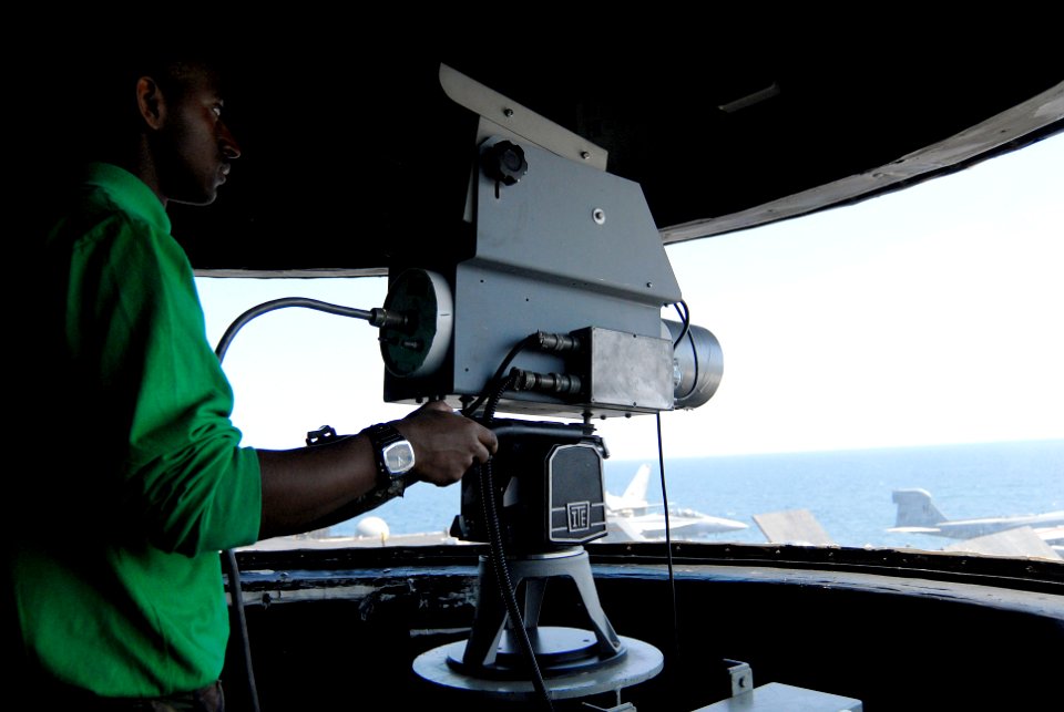 US Navy 070317-N-3038W-083 Electrician's Mate Fireman Marc Newsome operates a closed circuit video camera in the Intregrated Landing and Recovery Television System Center during flight operations aboard the Nimitz-class aircra