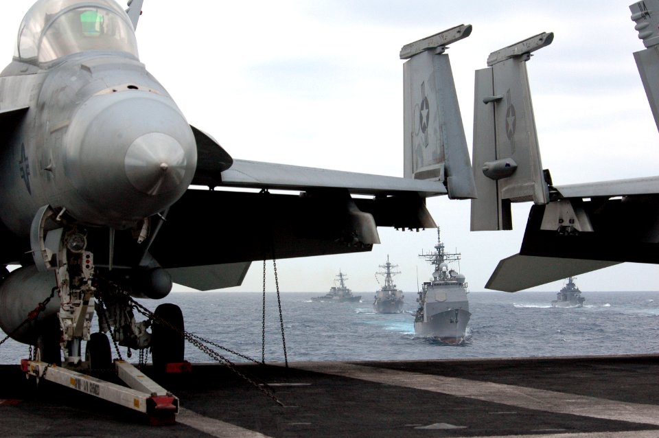 US Navy 070318-N-1635S-001 Moving forward from behind USS Ronald Reagan (CVN 76), USS Lake Champlain (CG 57) steams by on the port side during a pass in review of ships from Ronald Reagan Carrier Strike Group and Japan Maritime