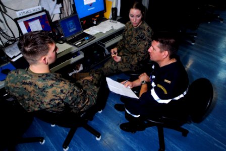 US Navy 070321-N-2659P-031 Sgt. Ryan Phelan and 1st Lt. Arianne Boldizar, assigned to Marine Strike Fighter Squadron (VMFA) 323, discuss coalition operations with French Master Chief Pasacal Gonzalez from the French Navy Ship (
