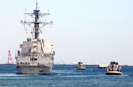 US Navy 070319-N-2638R-003 Large harbor tug Opelika (YTB 798) and Kittanning (YTB 787) follow alongside the Arleigh Burke-class guided missile destroyer USS Mustin (DDG 89) as she gets underway on board Commander Fleet Activiti