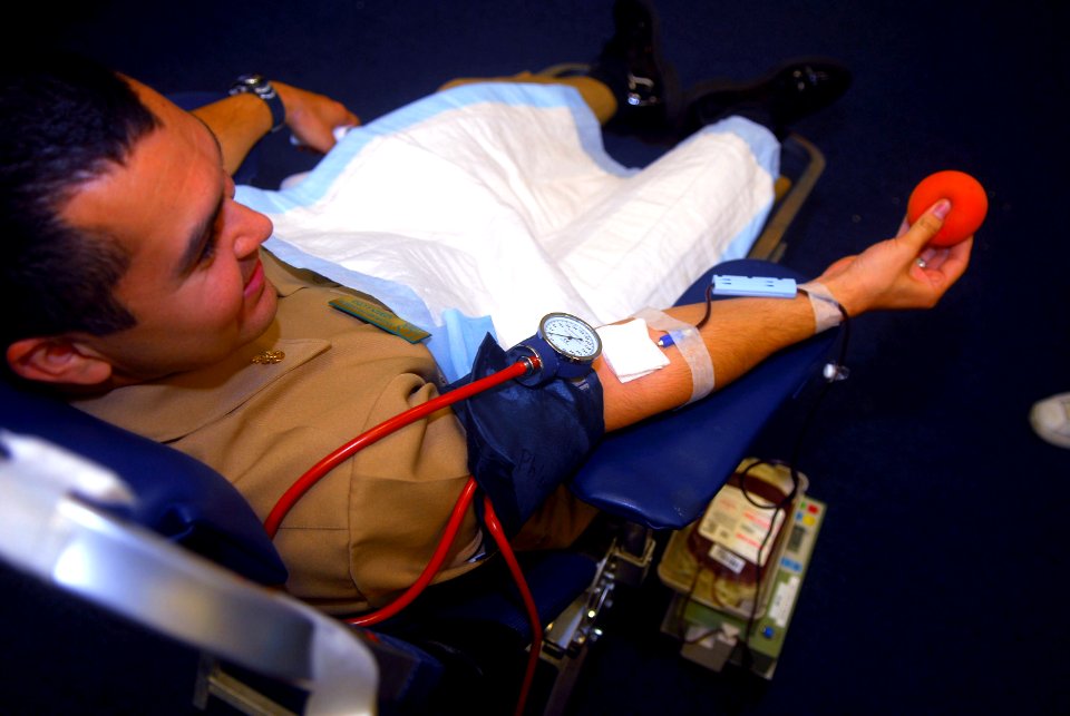 US Navy 070321-N-4776G-072 Chief Yeoman Rafael Villarreal, from San Antonio, rolls a foam ball in his hand promoting blood flow allowing him to fill a bag during a blood drive held on 32nd Street Naval Base
