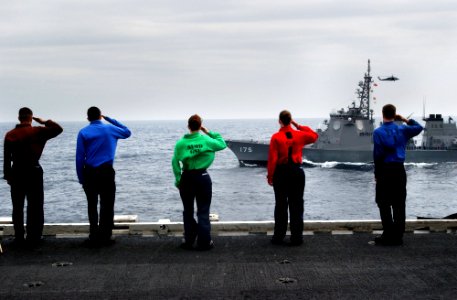 US Navy 070318-N-4009P-150 Sailors aboard Nimitz-class aircraft carrier USS Ronald Reagan (CVN 76) salute Japan Maritime Self Defense Force (JMSDF) ship JS Myoko (DDG 175) while manning the rails during a pass in review between
