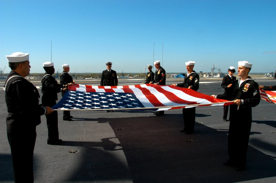 US Navy 070323-N-7695R-003 The flag detail on board USS John F. Kennedy (CV 67) retire the National Ensign for the last time during the decommissioning ceremony of the naval warship