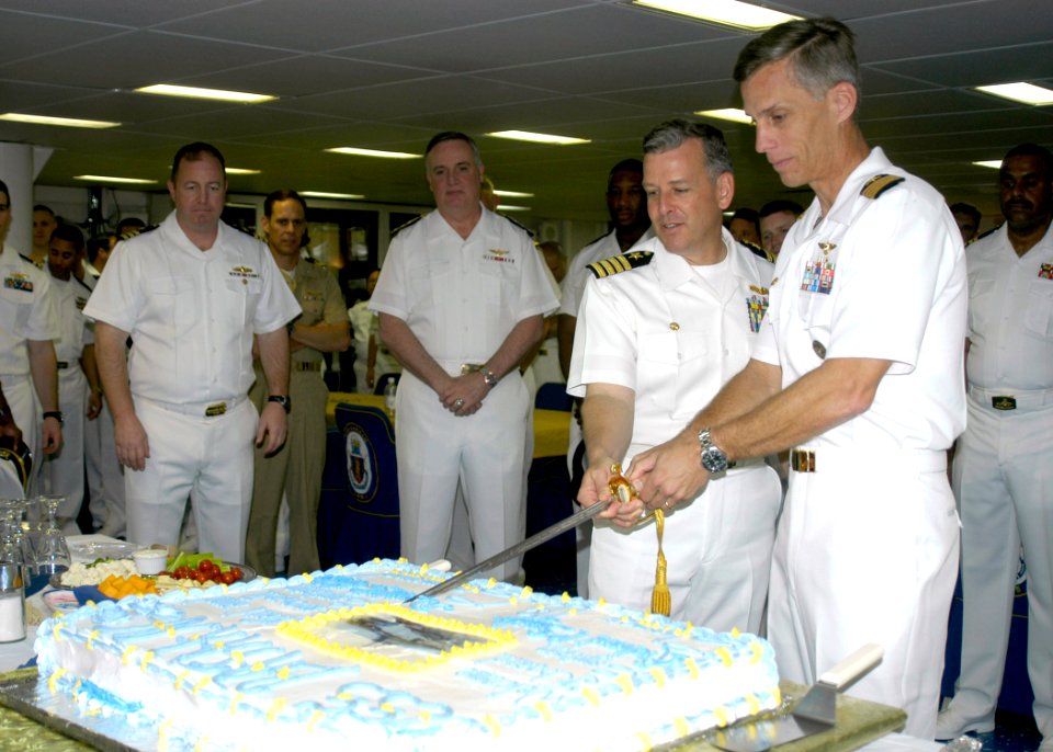 US Navy 070322-N-2636M-019 Capt. Richard P. Snyder and Capt. David Hulse cut the cake during a change of command reception held aboard amphibious assault ship USS Bataan (LHD 5)