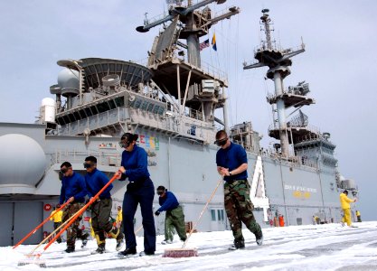 US Navy 070326-N-1328S-003 Sailors assigned to the amphibious assault ship USS Boxer (LHD 4), clean the ship's flight deck with Aqueous Film Forming Foam (AFFF)
