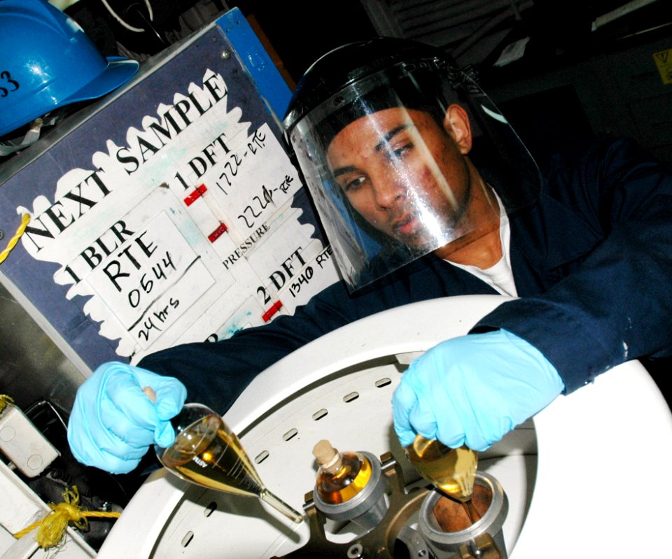 US Navy 070321-N-9758L-061 Machinist's Mate Fireman Zahir N. Khan puts fuel samples in the centrifuge testing for bottom sediments and water while Essex takes on fuel at Akasaki Fueling Station in preparation for the 46th Exerc