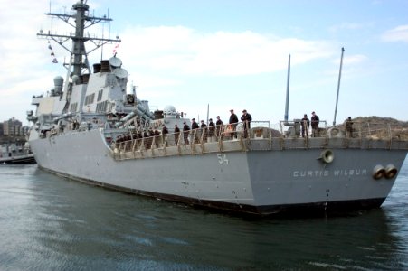 US Navy 070319-N-5253W-002 Sailors man the rails aboard the Arleigh Burke-class guided missile destroyer USS Curtis Wilbur (DDG 54) as she pulls away from forward deployed operating base Commander Fleet Activities Yokosuka
