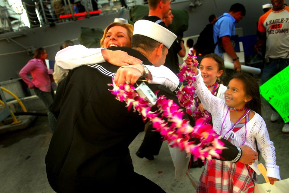 US Navy 070321-N-4776G-130 Operations Specialist 1st Class Korey Herinckx, sweeps his family into his arms after the Navy's newest guided missile destroyer USS Gridley (DDG 101) pulled into port during their homeport ceremony