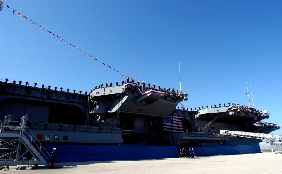 US Navy 070323-N-3285B-100 Sailors stationed aboard USS John F. Kennedy (CV 67) man the rails during the ship's decommissioning ceremony