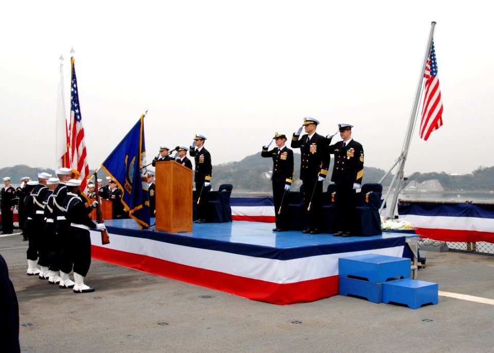 US Navy 070327-N-9860Y-024 Capt. Jeff Bartkoski and Capt. David A. Lausman render honors to the color guard during a change of command ceremony held on the flight deck of amphibious command ship USS Blue Ridge (LCC 19)