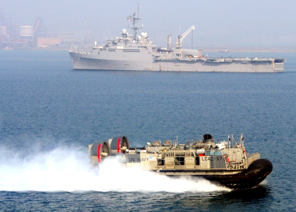 US Navy 070323-N-6710M-004 A landing craft air cushion (LCAC) prepares to enter the well deck of dock landing ship USS Tortuga (LSD 46) while passing by amphibious transport dock USS Juneau (LPD 10)