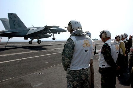 US Navy 070328-N-1635S-002 Commander United Nations Command, Combined Forces Command United States Forces Korea, Gen. B.B. Bell, left, watches the landing of an F-A-18E Super Hornet with a group of distinguished visitors (DV)