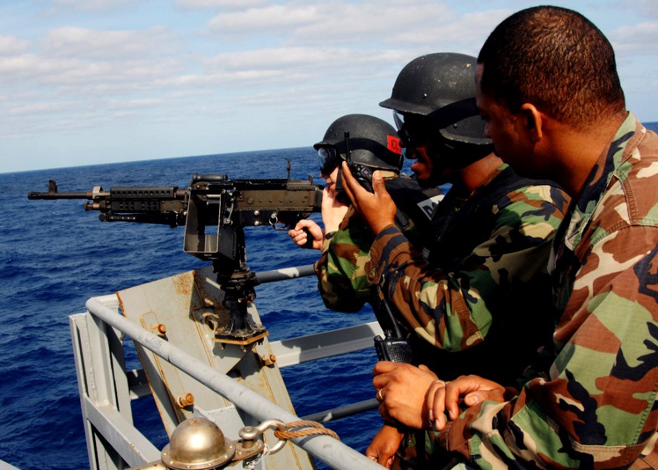 US Navy 070326-N-8923M-040 Sailors assigned to security department man an M-240 gun mount in the catwalk aboard Nimitz-class aircraft carrier USS Harry S. Truman (CVN 75)