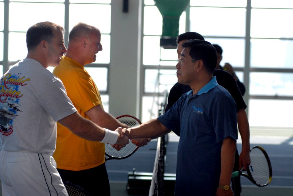 US Navy 070323-N-2959L-025 USS Ronald Reagan (CVN 76) Commanding Officer, Capt. Terry Kraft and Cmdr. James Hineline shake hands before beginning a tennis match