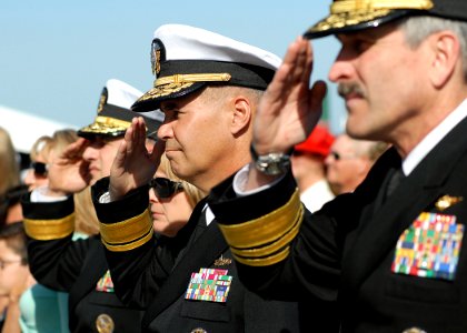 US Navy 070323-N-4565G-007 Navy Flag officers salute the color guard during the playing of the national anthem at the beginning of the USS John F. Kennedy (CV 67) decommissioning ceremony photo
