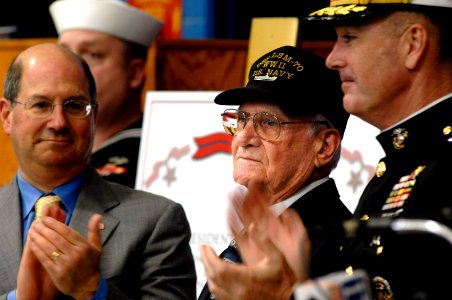 US Navy 070323-N-3642E-498 U.S. Navy veteran Paul E. Baker, center, receives applause after receiving a Bronze Star with Combat