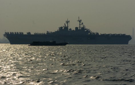 US Navy 070323-N-9758L-180 Landing Craft Utility (LCU) 1631 anchors near amphibious assault ship USS Essex (LHD 2) to allow landing craft air cushion (LCACs) to enter Essex during an onload of marines