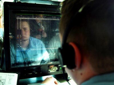 US Navy 070327-N-8923M-110 Aviation Boatswain's Mate (Handling) Airman Edward Henning watches the primary event board during flight operations in primary flight control aboard Nimitz-class aircraft carrier USS Harry S. Truman (