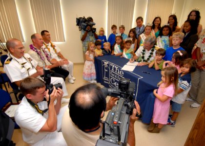US Navy 070329-N-4965F-001 Commander, Navy Region Hawaii and Naval Surface Group Middle Pacific, Rear Adm. T. G. Alexander signs a Month of the Military Child and Child Abuse Prevention Month proclamation photo