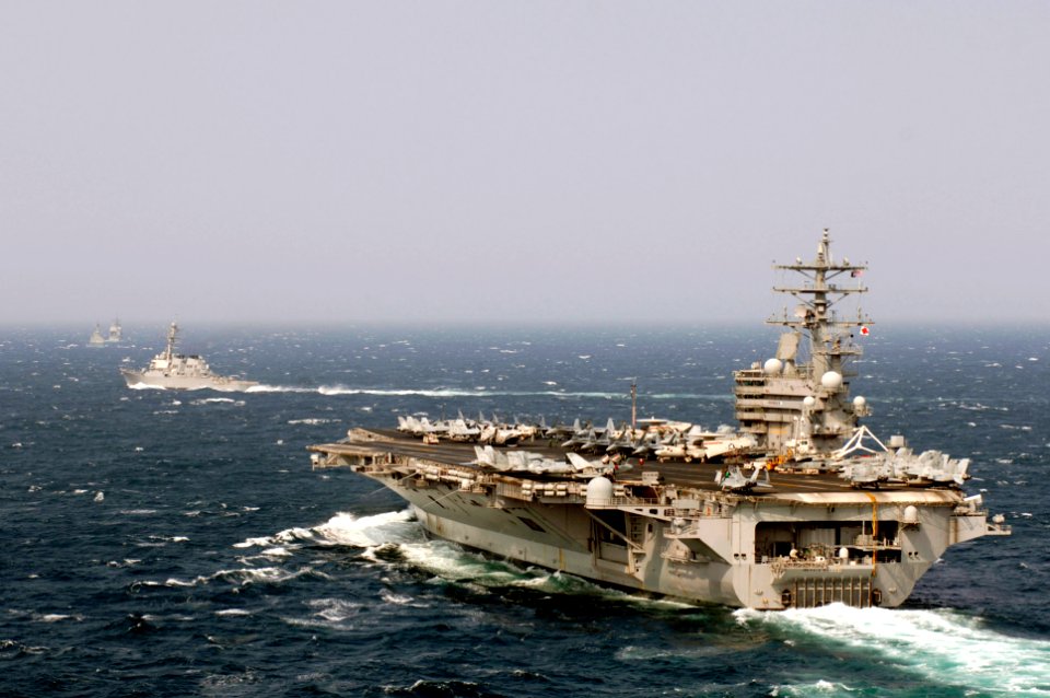 US Navy 070327-N-7130B-012 Cruising in the Western Pacific Ocean, USS Ronald Reagan (CVN 76) maneuvers into position for a Photo Exercise (PHOTOEX) with the members of the Ronald Reagan Strike Group