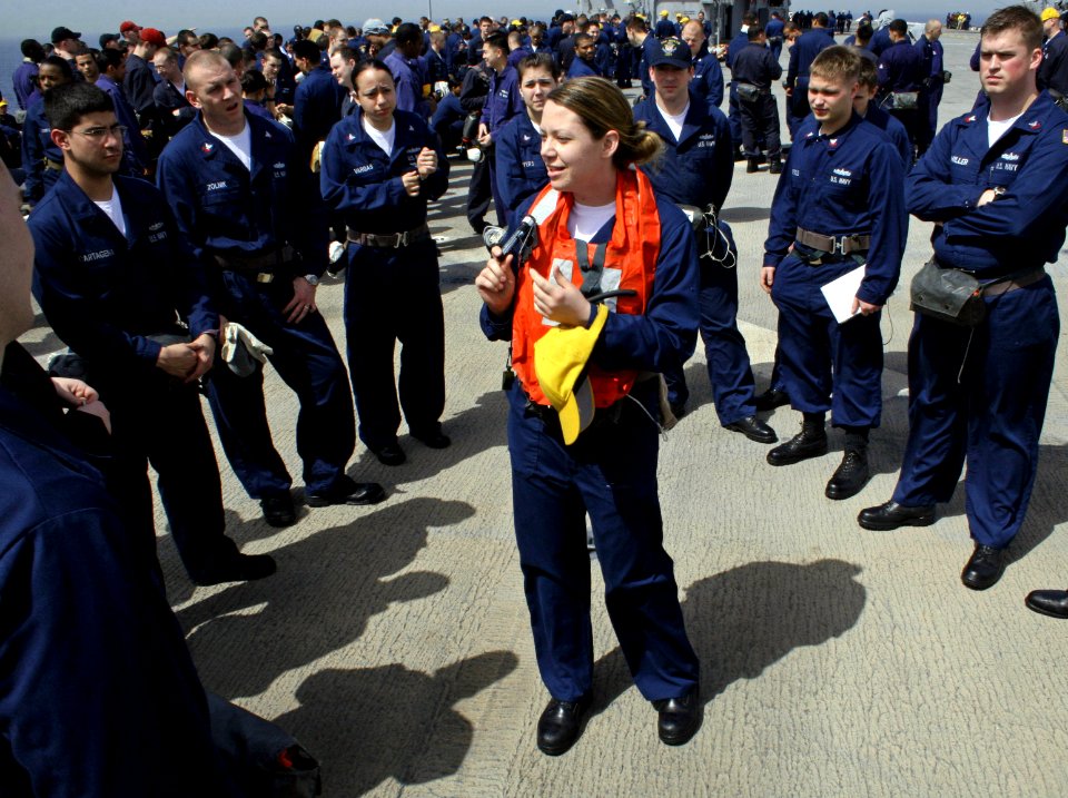 US Navy 070327-N-1328S-002 Intelligence Specialist 2nd Class Jessica Bacak assigned to the amphibious assault ship USS Boxer (LHD 4), instructs a group of Sailors on how to properly don a life jacket during an abandon ship dril