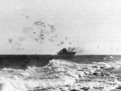 USS Enterprise (CV-6) under attack and burning during the Battle of the Eastern Solomons on 24 August 1942 (NH 97778) photo