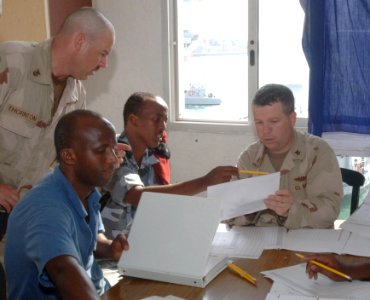 US Navy 070328-N-1003P-002 Master Chief Engineman Shannon Thornton and Electrician's Mate 1st Class Brent Arntzen assigned to Combined Joint Task Force-Horn of Africa's Mobile Training Team teach members of the Djiboutian Navy