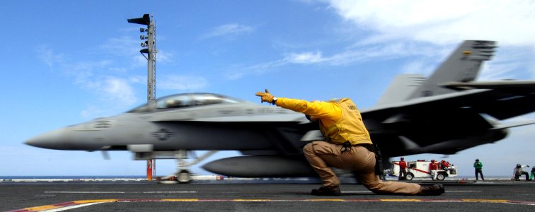 US Navy 070402-N-5345W-062 Lt. Cmdr. Alan D'Jock ducks into his shoot stance as an F-A-18F Super Hornet assigned to the Swordsmen of Strike Fighter Squadron (VFA) 32