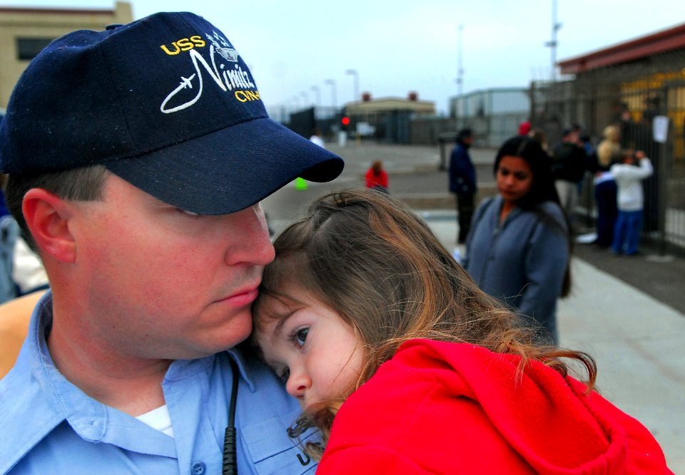 US Navy 070402-N-4776G-019 Electronics Technician 2nd Class Michael O'Brien's daughter hugs her father before he departs aboard the nuclear-powered aircraft carrier USS Nimitz (CVN 68)