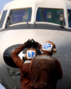 US Navy 070327-N-5345W-070 Pilots assigned to the Seahawks of Carrier Airborne Early Warning Squadron (VAW) 126, show that their hands are clear of the controls as their plane captain guides